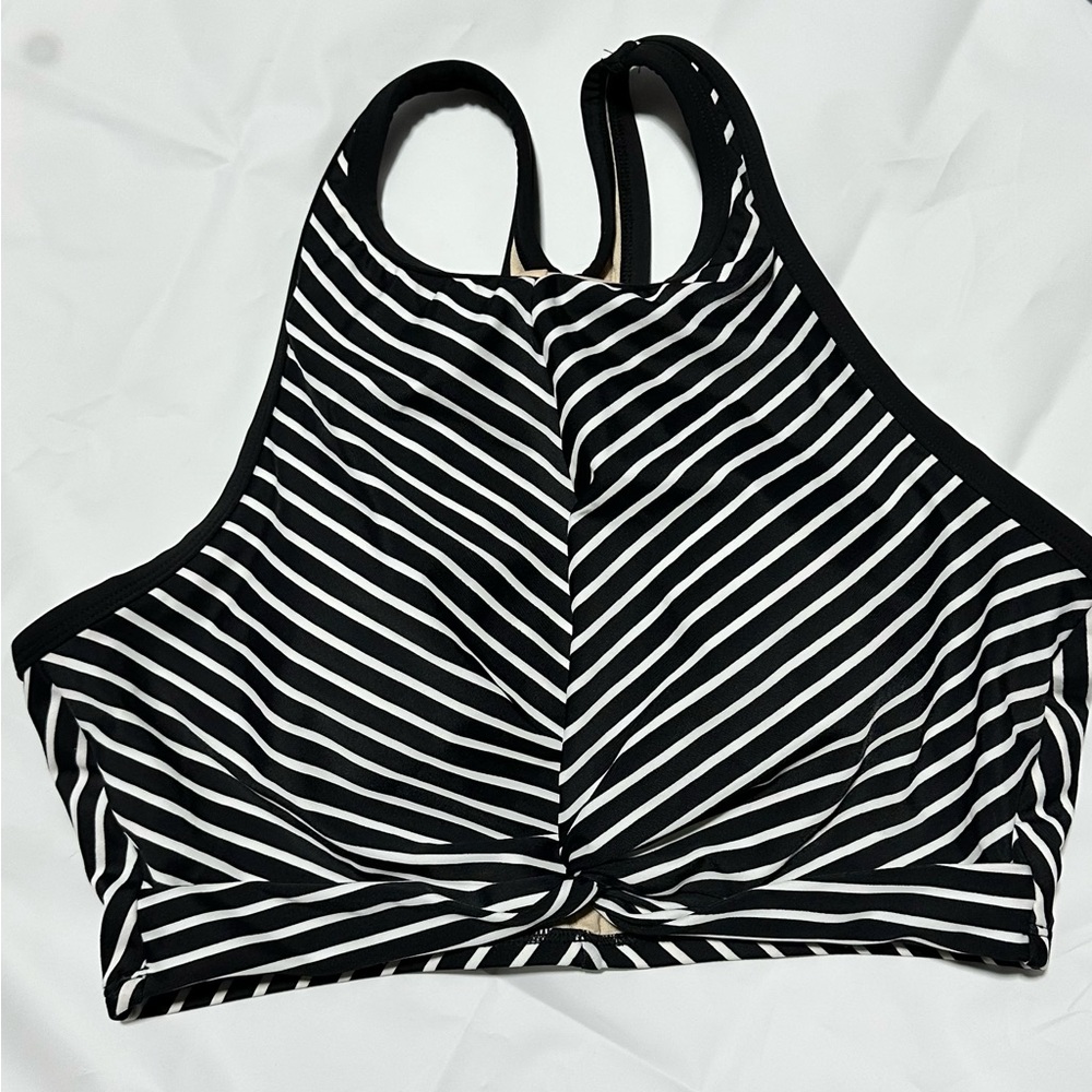 Medium Kona Sola black and white striped swim top.